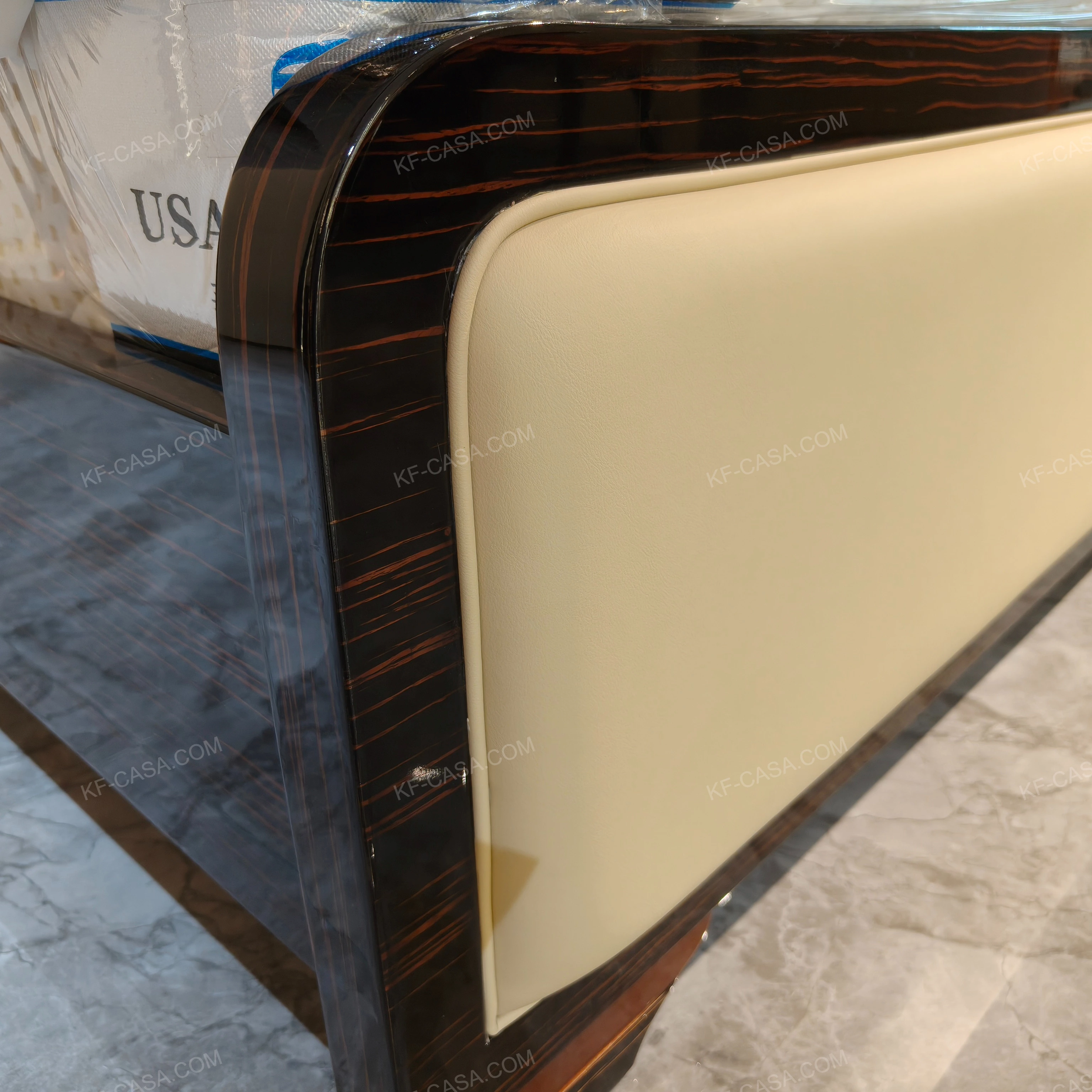 Cream Leather Upholstered Bed with Dark Natural Wood Veneer Trim, Embossed Brand Emblem & Copper-Accented Hardware